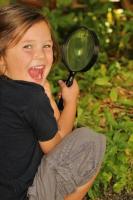 Child with magnifying glass.