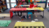 Students painting a lavalava.