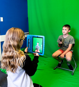 Two students filming with iPad.